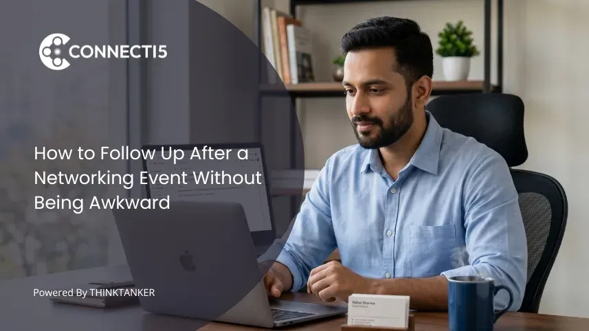 Professional man writing a networking follow-up email on a laptop with a business card on the desk, Connecti5 contact management app